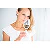 Gorgeous young woman with a glass of wine, smelling the lovely drink, savouring   every sip (shallow DOF; color toned image)