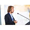 Handsome young man giving a speech at a conference