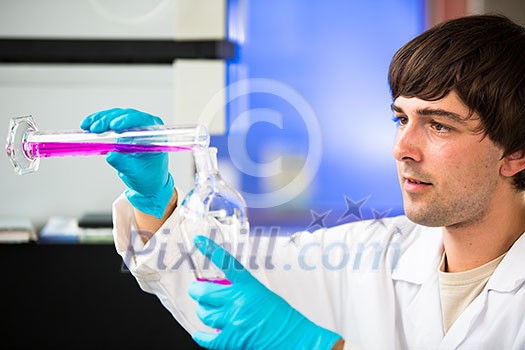 Young male researcher carrying out scientific research in a lab (shallow DOF; color toned image) Young male researcher carrying out scientific research in a lab (shallow DOF; color toned image)