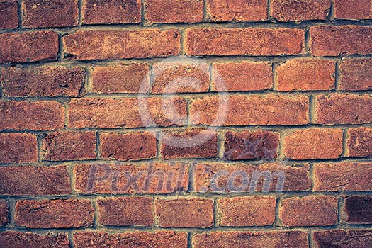 Weathered red brick wall background with vignette eccet, grungy rusty blocks ofcolorful horizontal architecture