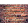 Weathered red brick wall background with vignette eccet, grungy rusty blocks ofcolorful horizontal architecture