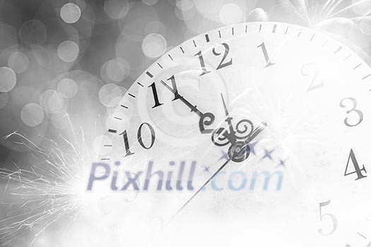Conceptual image of clock with bokeh lights and firework