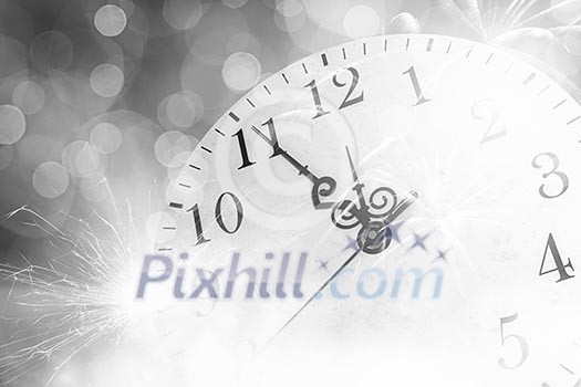 Conceptual image of clock with bokeh lights and firework Conceptual image of clock with bokeh lights and firework
