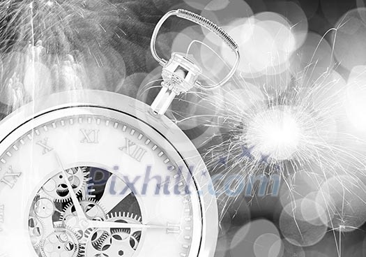 Conceptual image of clock with bokeh lights and firework