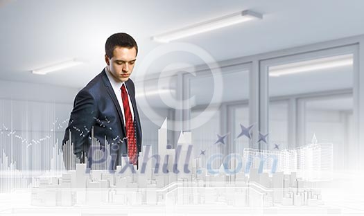 Businessman looking at digital construction project of modern city Businessman looking at digital construction project of modern city