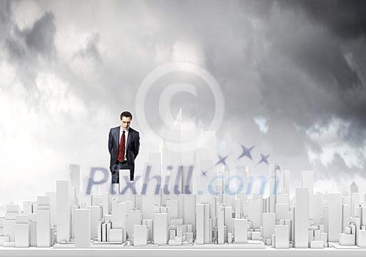 Businessman looking at digital construction project of modern city Businessman looking at digital construction project of modern city