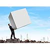 Young businessman carrying white blank cube. Place for text