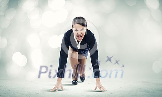 Young pretty businesswoman in suit ready to run