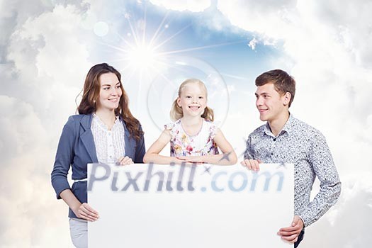 Young happy family with white blank banner. Place for text