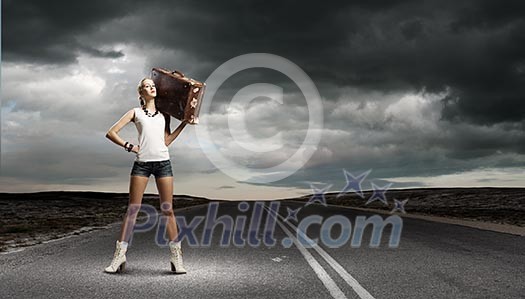 Young woman hiker walking with suitcase on shoulder Young woman hiker walking with suitcase on shoulder