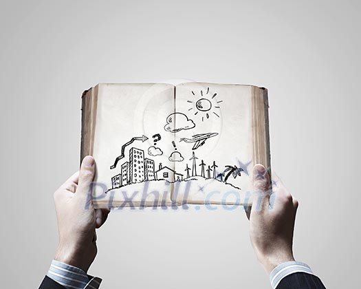 Close up of businessman hands holding opened notepad with sketches Close up of businessman hands holding opened notepad with sketches