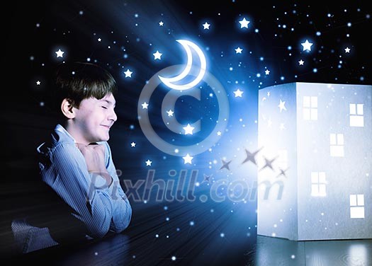 Cute little boy looking at model of house Cute little boy looking at model of house