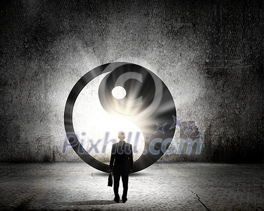 Rear view of businessman looking at yin yang sign Rear view of businessman looking at yin yang sign