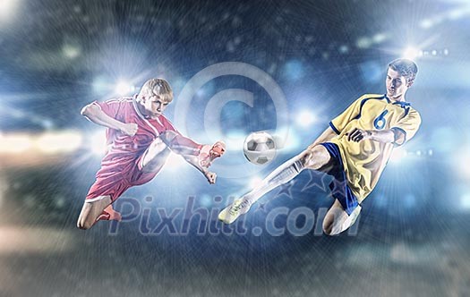 Two young football players struggling for ball Two young football players struggling for ball