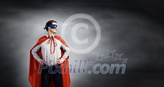 Young confident superman in mask and cape Young confident superman in mask and cape
