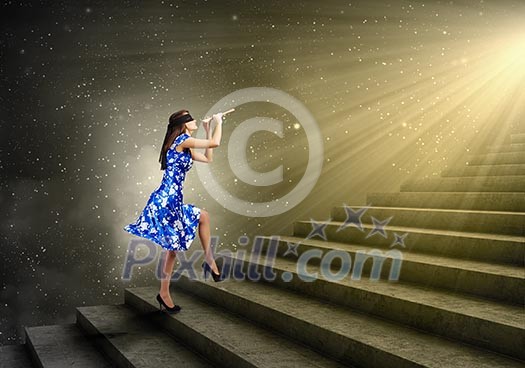 Young woman in blue dress playing fife and stepping the ladder