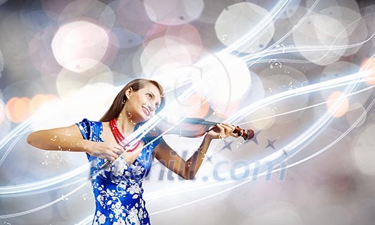 Young attractive woman in blue dress playing violin