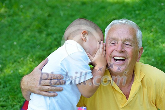 happy grandfather and child have fun and play in park