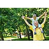 happy grandfather and child have fun and play in park