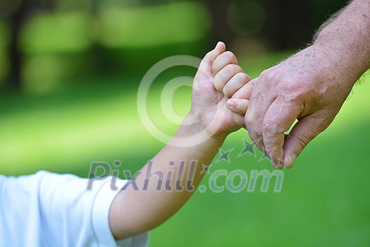 happy grandfather and child have fun and play in park