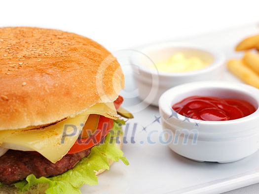 still life with fast food hamburger menu, french fries, soft drink and ketchup still life with fast food hamburger menu, french fries, soft drink and ketchup
