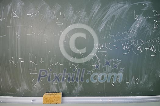 green board at university classroom with writen ecenomy and finance formulas green board at university classroom with writen ecenomy and finance formulas