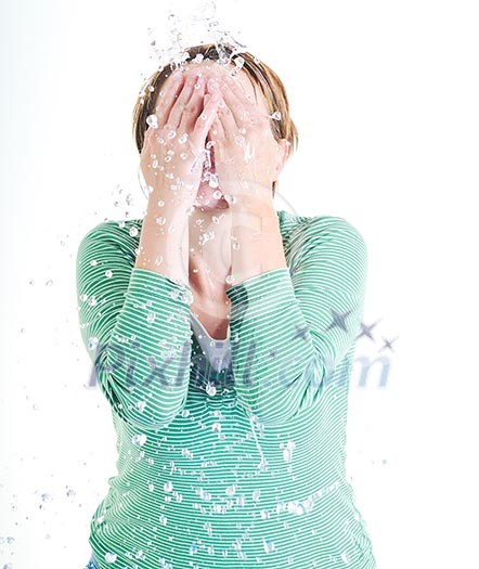 bautiful young woman wash face with clean water isolated on white in studio