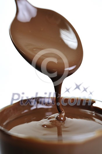 macro shoot with hot chocolate falling from spooin isolated on white in studio 