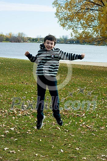 happy boy jumping in the park, joy, emotion happy boy jumping in the park, joy, emotion