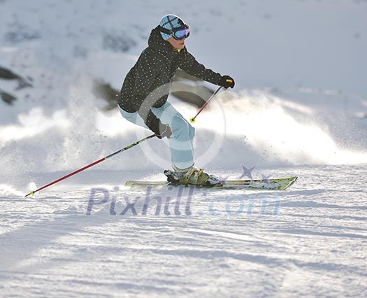 young healthy woman skiing on fresh snow at winter season in france alps