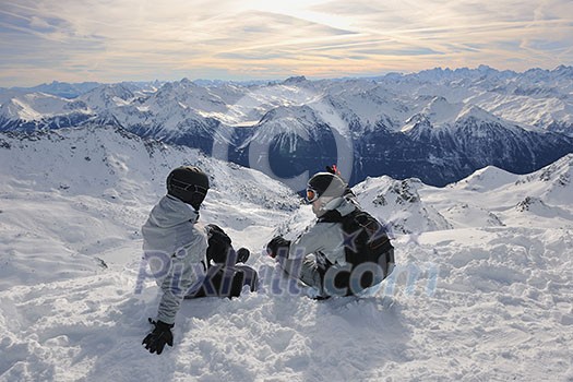 happy people group have fun on snow at winter season on mountain with blue sky and fresh air