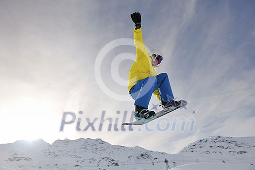 happy young man have fun at  mountain peak on winter season with beautiful sunset 