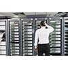 it business man in network server room have problems and looking for  disaster situation  solution