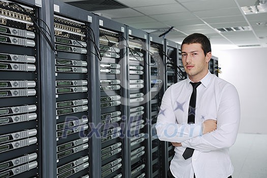 young handsome business man engeneer in datacenter server room young handsome business man engeneer in datacenter server room