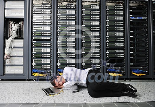 business man in network server room have problems and looking for disaster solution business man in network server room have problems and looking for disaster solution