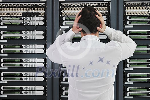business man in network server room have problems and looking for disaster solution business man in network server room have problems and looking for disaster solution