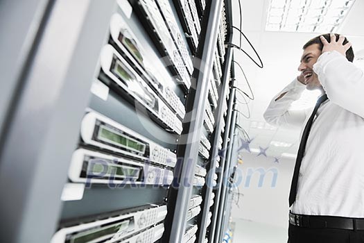 business man in network server room have problems and looking for disaster solution business man in network server room have problems and looking for disaster solution