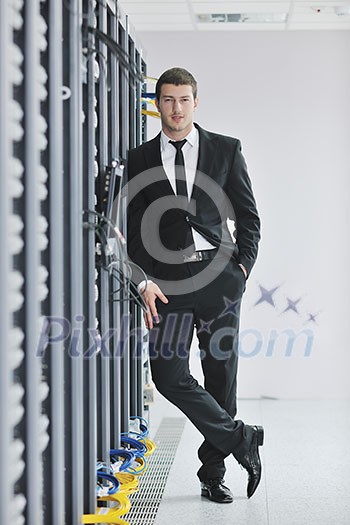 young handsome business man engeneer in datacenter server room young handsome business man engeneer in datacenter server room