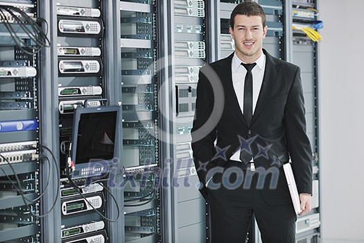 young handsome business man engeneer in datacenter server room young handsome business man engeneer in datacenter server room