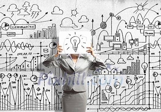 Businesswoman hiding her face with sheet of paper with sketches at background Businesswoman hiding her face with sheet of paper with sketches at background