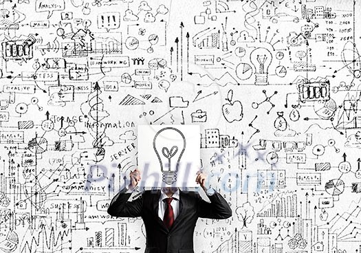 Businessman hiding his face with sheet of paper with sketches at background Businessman hiding his face with sheet of paper with sketches at background