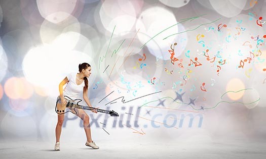Young girl in shorts playing on imaginary guitar Young girl in shorts playing on imaginary guitar