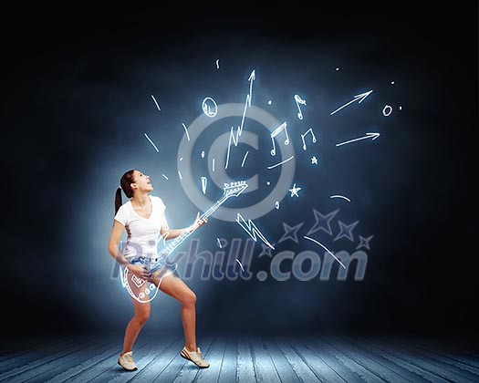 Young girl in shorts playing on imaginary guitar