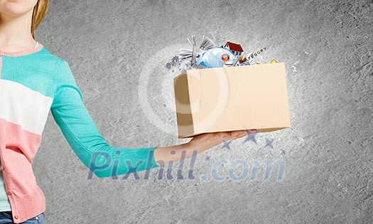 Close up of female hand holding carton box with colorful splashes