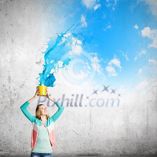 Young girl holding bucket with colorful splashes Young girl holding bucket with colorful splashes