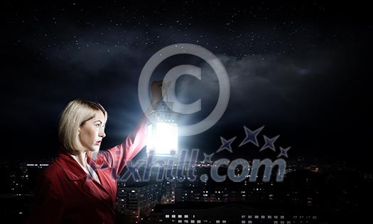 Young blond woman in red cloak with lantern Young blond woman in red cloak with lantern