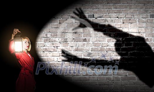 Young blond woman in red cloak with lantern Young blond woman in red cloak with lantern
