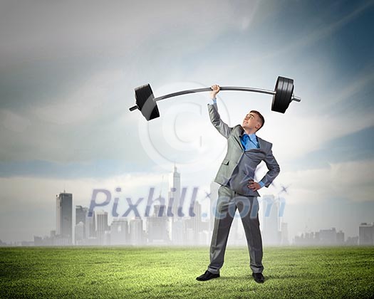 Image of strong businessman lifting barbell above head with one hand Image of strong businessman lifting barbell above head with one hand