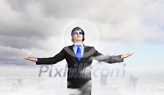 Image of powerful businessman standing against urban scenics Image of powerful businessman standing against urban scenics