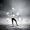 Image of businesswoman juggling with dollar symbols. Currency concept
